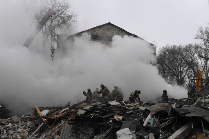 Donetsk's emergency employees work at a site of a shopping center destroyed after what Russian ...