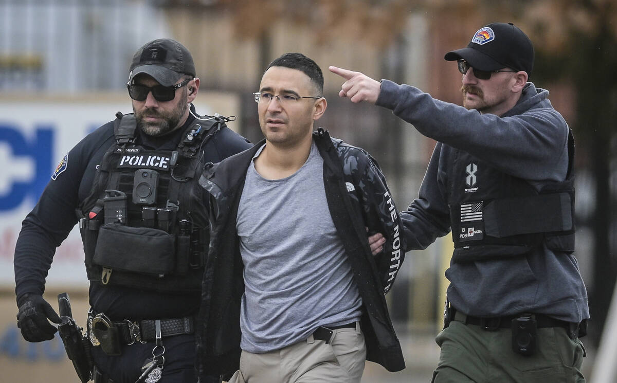 Solomon Pena, center, a Republican candidate for New Mexico House District 14, is taken into cu ...