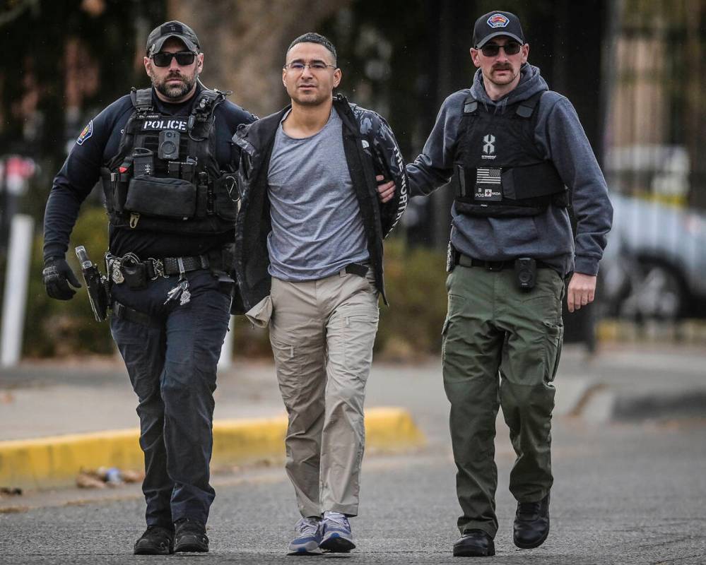 Solomon Pena, center, a Republican candidate for New Mexico House District 14, is taken into cu ...