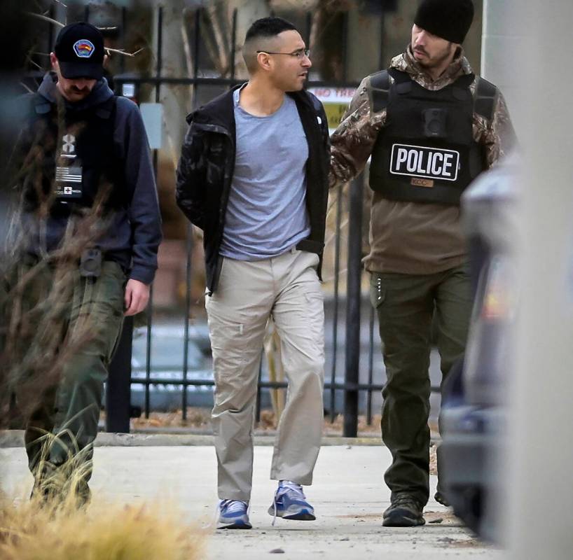 Solomon Pena, center, a Republican candidate for New Mexico House District 14, is taken into cu ...