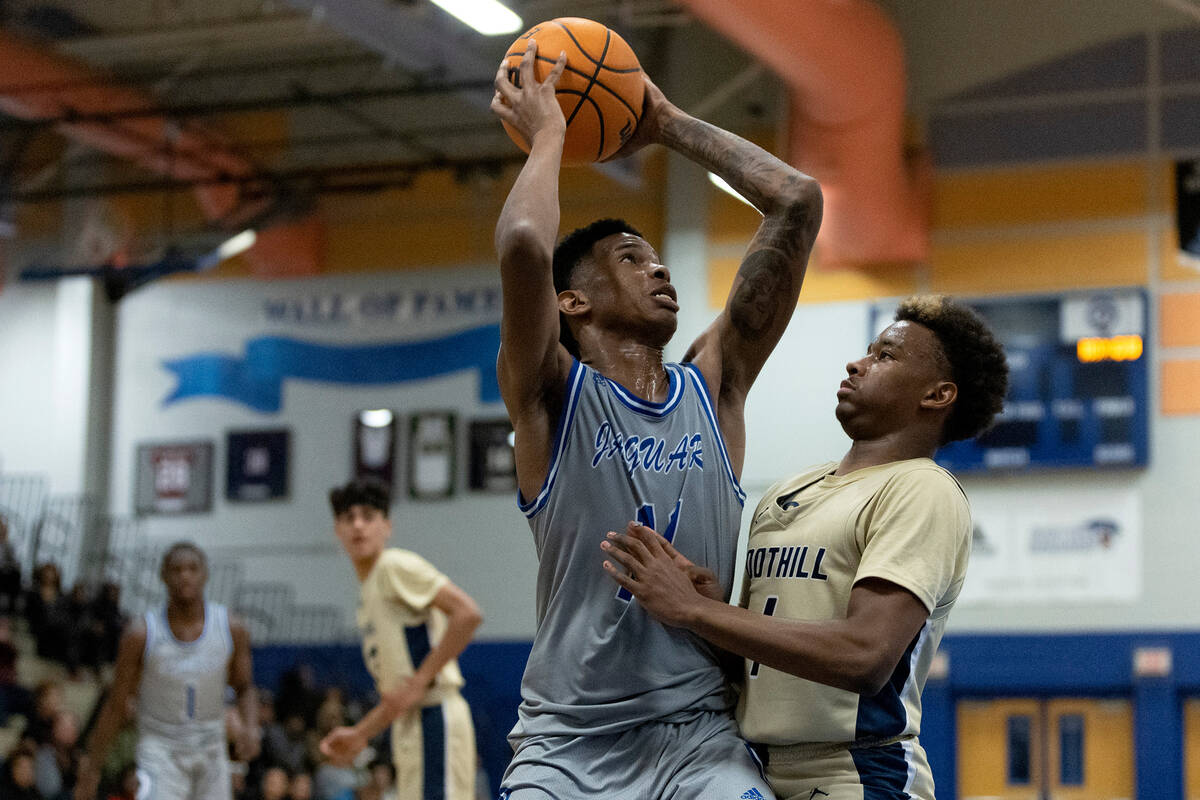 Desert Pines’ Evan Tatum (11) attempts to pass against Foothill’s Justin Brulee ( ...