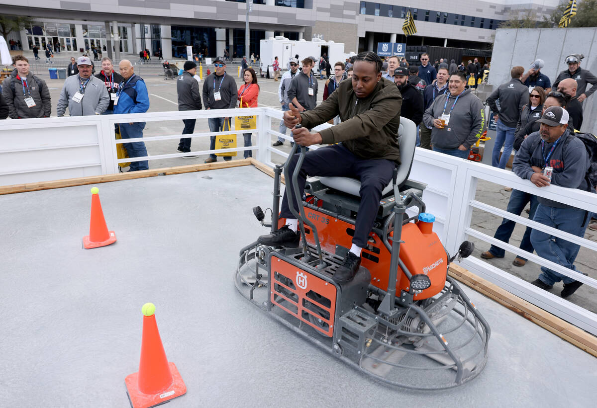 Bernard Gough of Canada glides a concrete leveling machine through a skills course in the Husqv ...