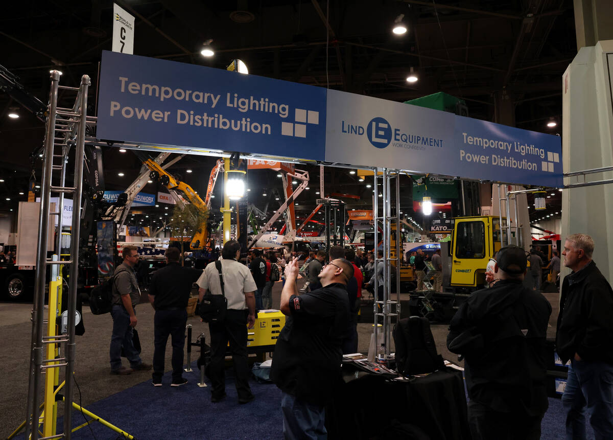 Joel Pina of Phoenix checks out lighting in the Lind Equipment booth on Day 1 of World of Concr ...