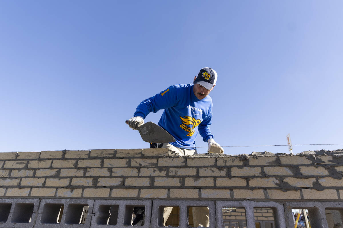 Cole Stamper participates in the World of Concrete Convention bricklaying competition pose for ...