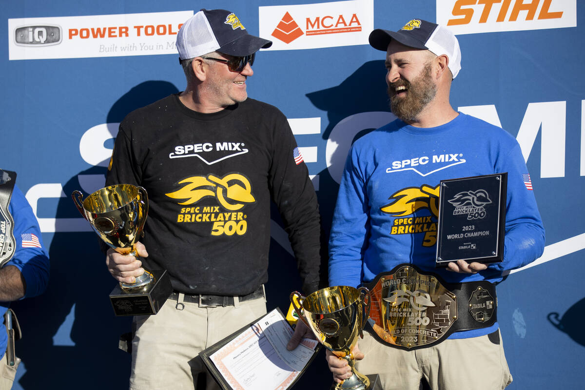 Mason Michael Schlund, right, a mason professional, with his tender Aaron Kowalski, pose after ...