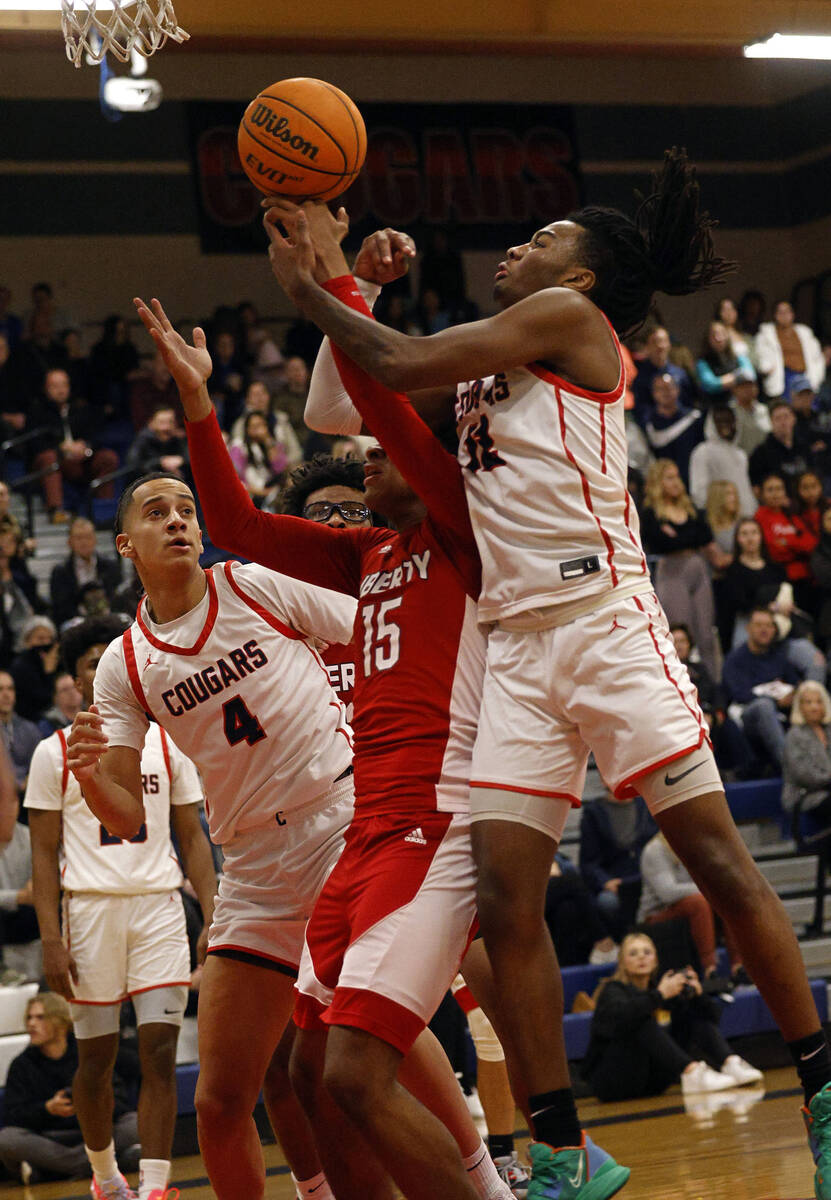 Coronado’s Sebastian Mack, right, shoots over Liberty’s Carlos Bradley (15) durin ...