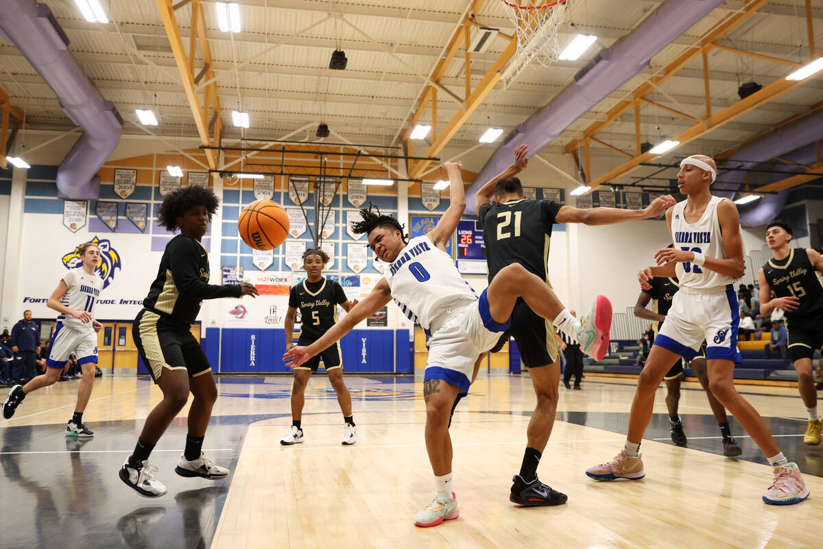 Sierra Vista's Ej Dacuma (0) loses the ball under pressure from Spring Valley's Devin Mabry (21 ...