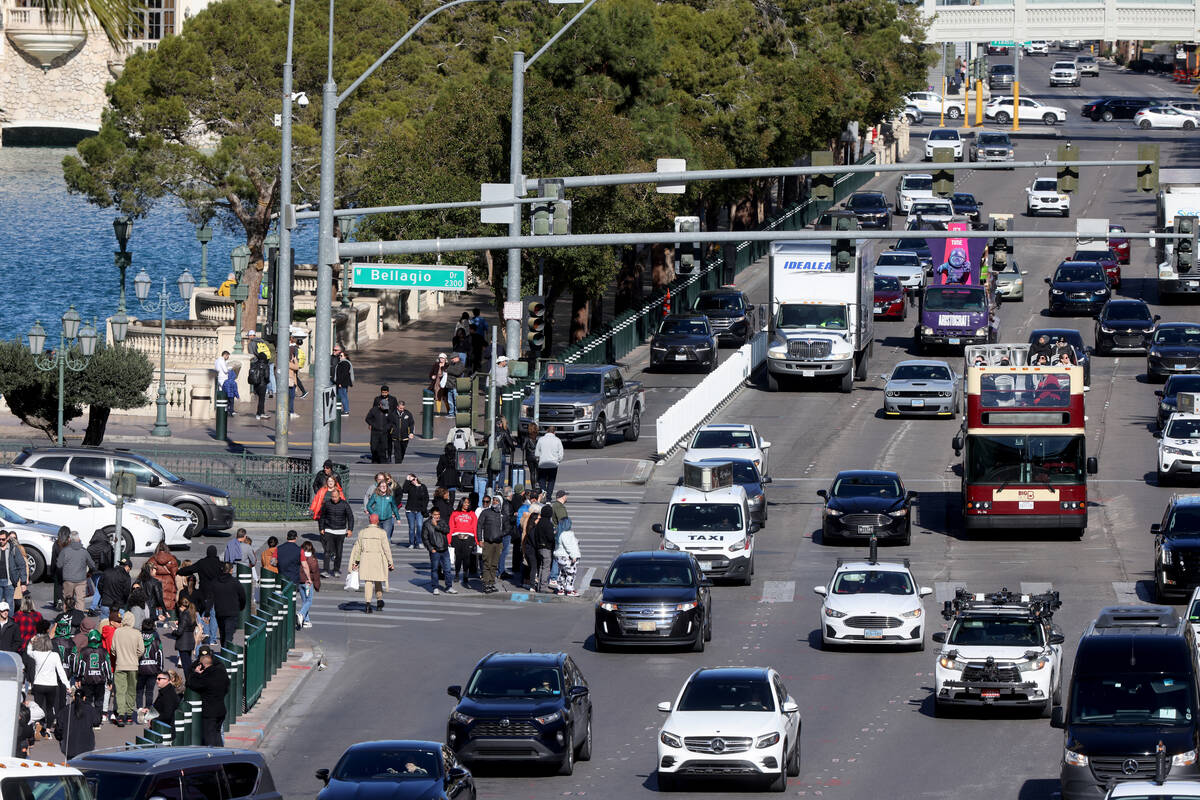 People and vehicles on the Strip at Bellagio Drive in Las Vegas Friday, Jan. 20, 2023. (K.M. Ca ...