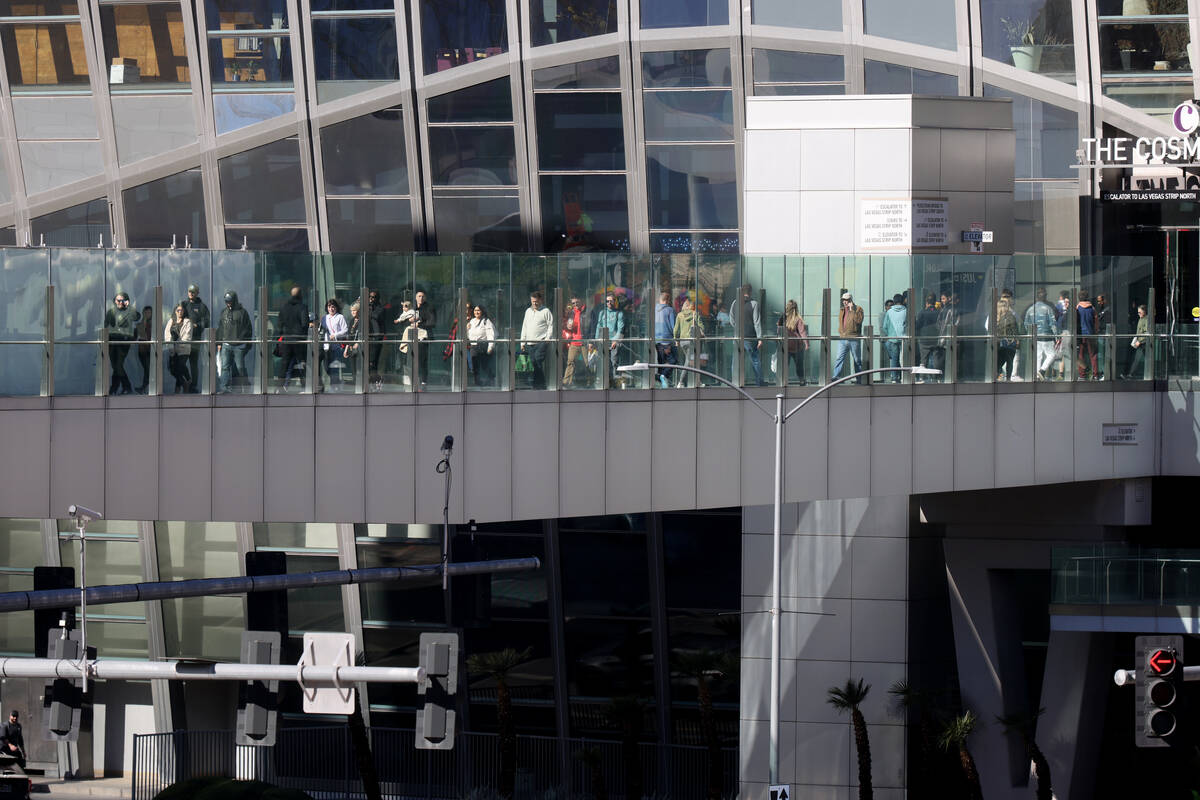 People and vehicles on the Strip at Harmon Avenue in Las Vegas Friday, Jan. 20, 2023. (K.M. Can ...