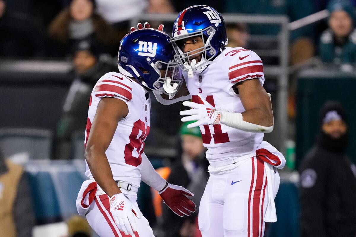 New York Giants running back Matt Breida, right, celebrates his touchdown run with Darius Slayt ...