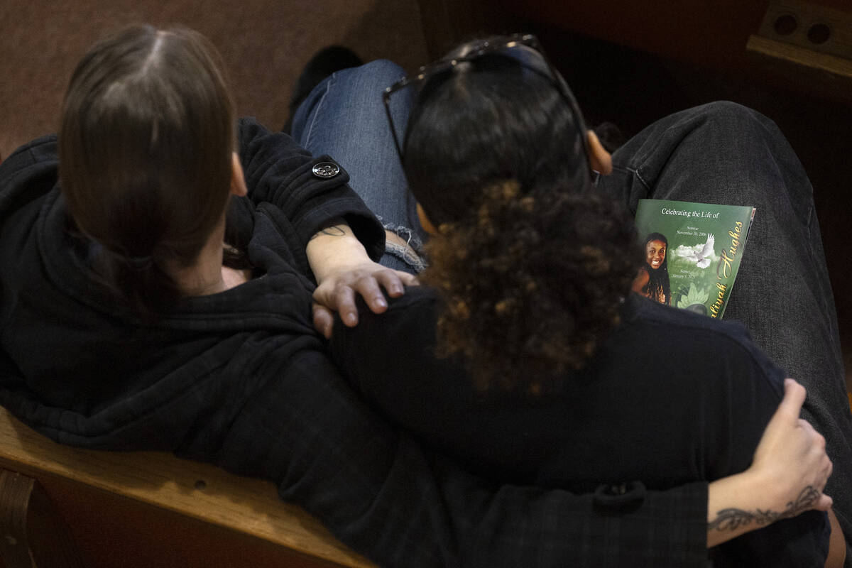 Attendees of a memorial for Ashari Hughes embrace during the service at New Bethel Baptist Chur ...