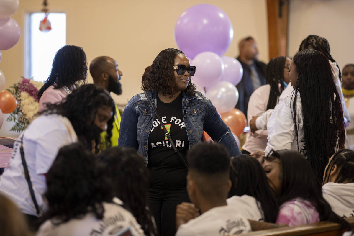 Attendees of a memorial for Ashari Hughes proceed past Hughes’ family at New Bethel Bapt ...