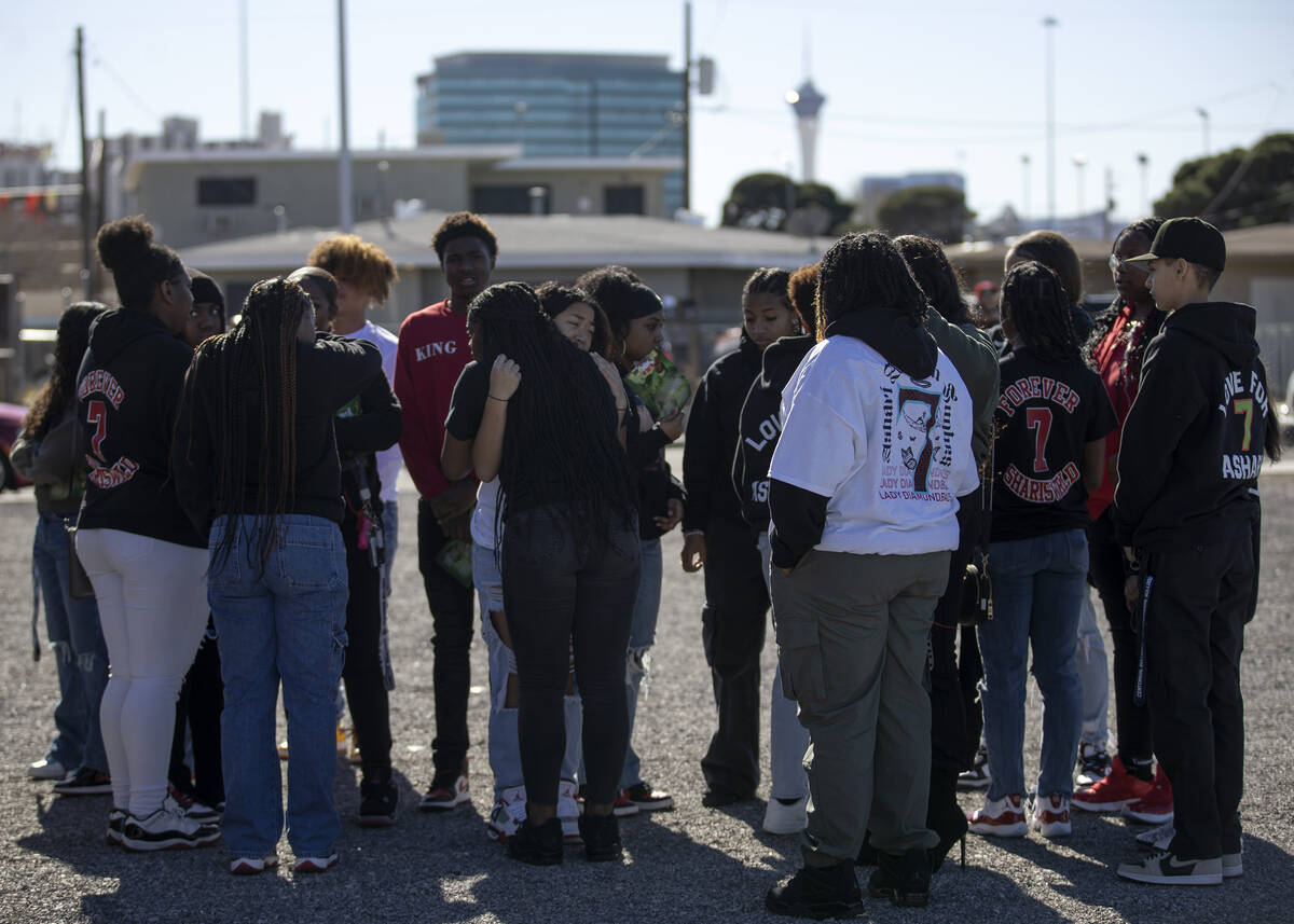 Friends and classmates of Ashari Hughes embrace after the teenager’s memorial at New Bet ...