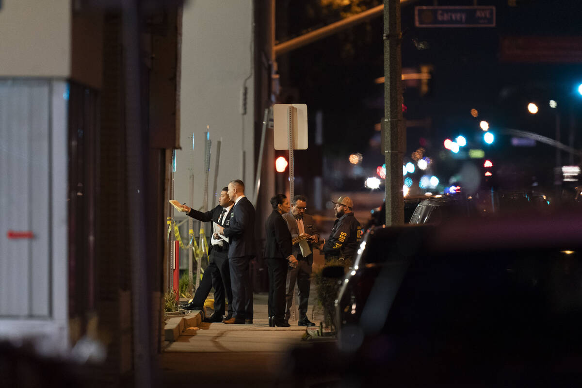 Investigators gather at a scene where a shooting took place in Monterey Park, Calif., Sunday, J ...