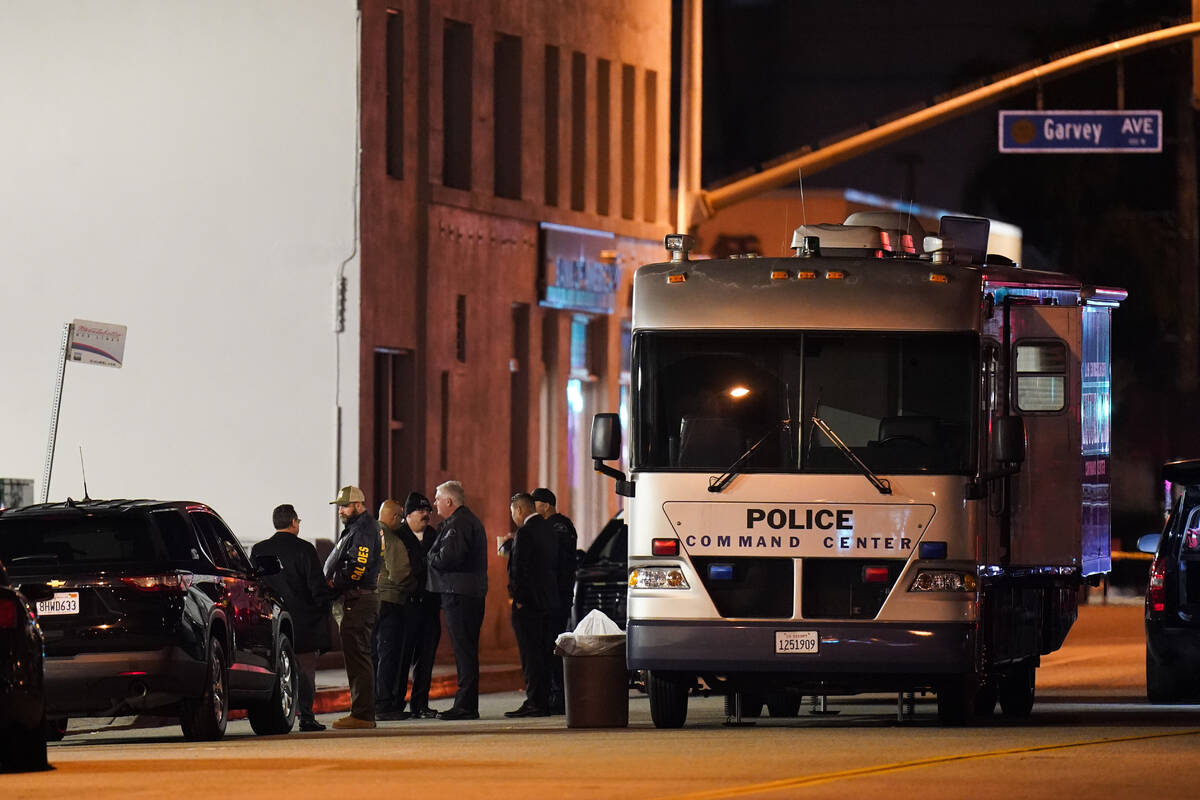 Investigators gather at a scene where a shooting took place in Monterey Park, Calif., Sunday, J ...