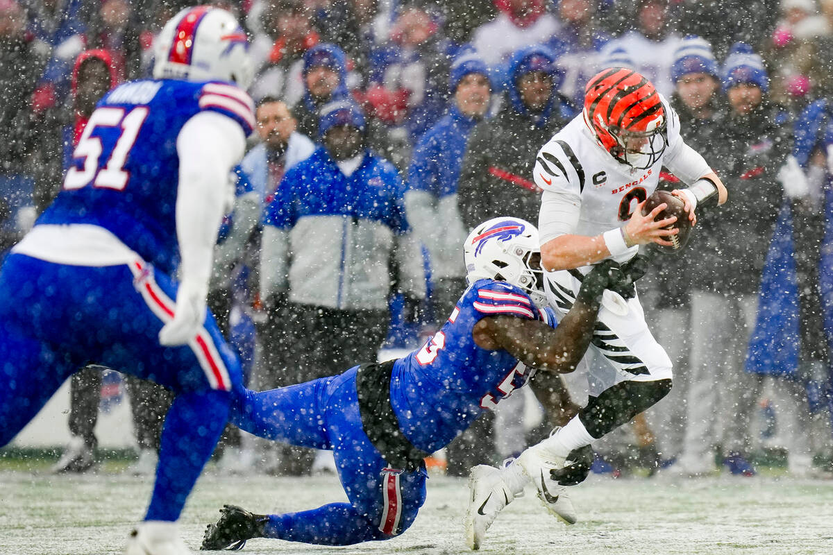 Cincinnati Bengals quarterback Joe Burrow (9) is tackled by Buffalo Bills defensive end Boogie ...