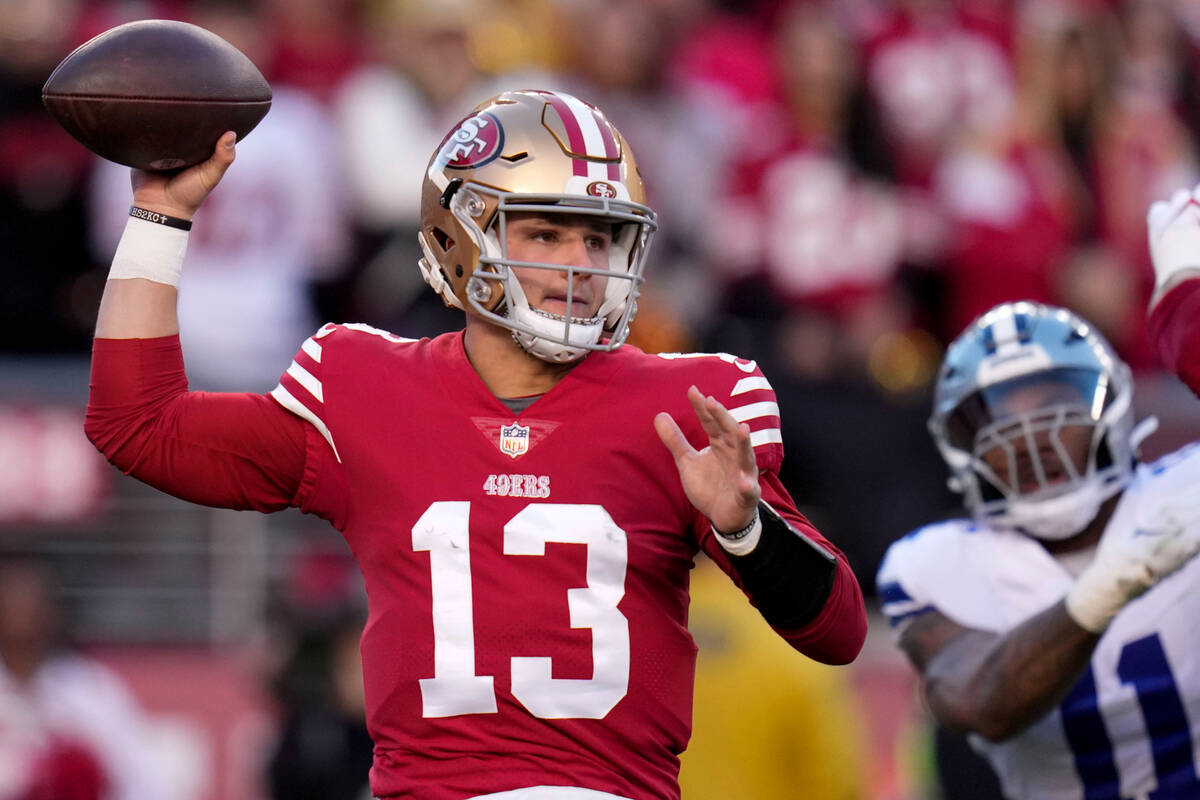 San Francisco 49ers quarterback Brock Purdy (13) passes in front of Dallas Cowboys linebacker M ...