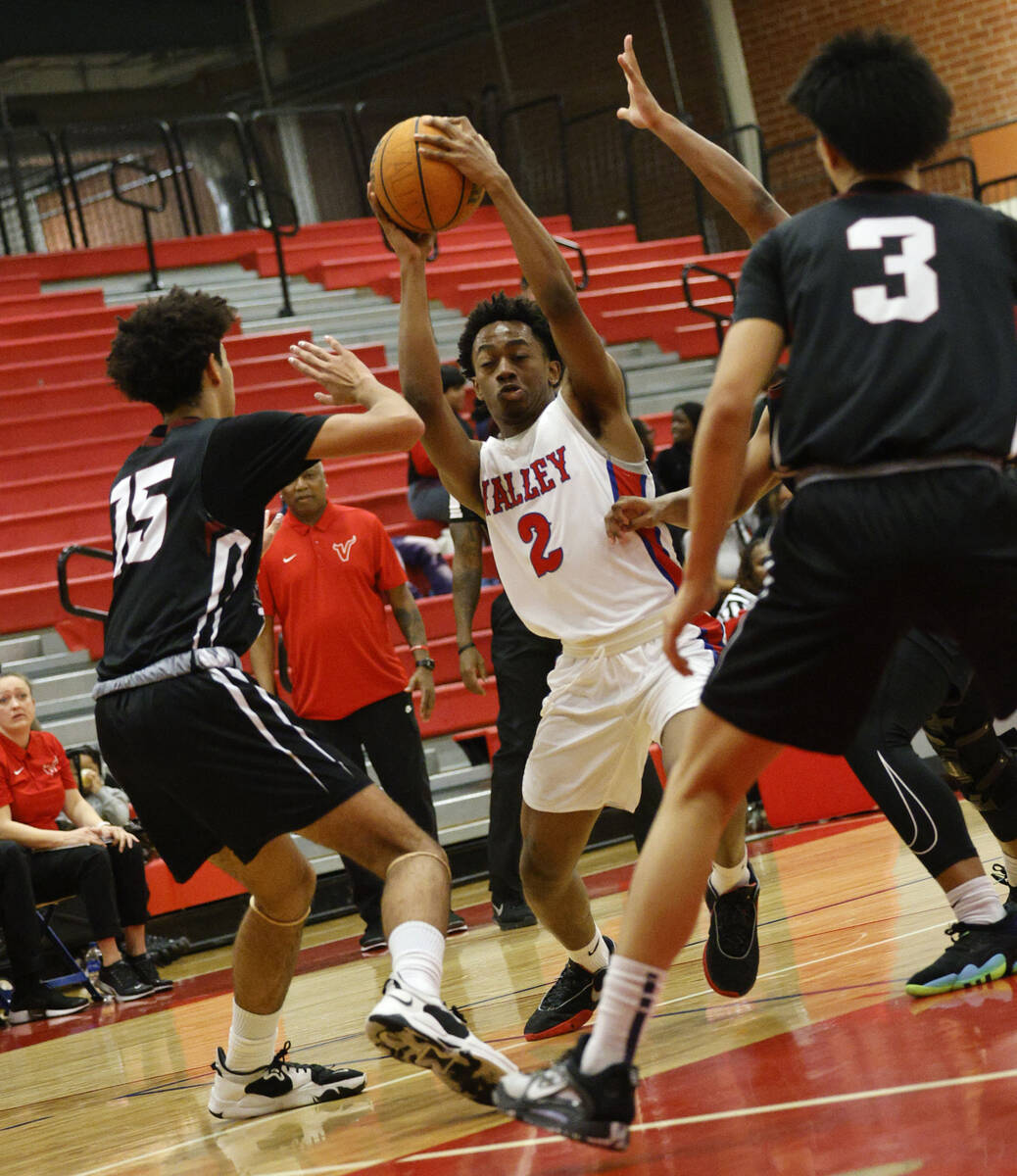 Valley's David Poole-Eskridge (2) shoots over Desert Oasis' Desmond Pyre (15) and Desert Oasis' ...