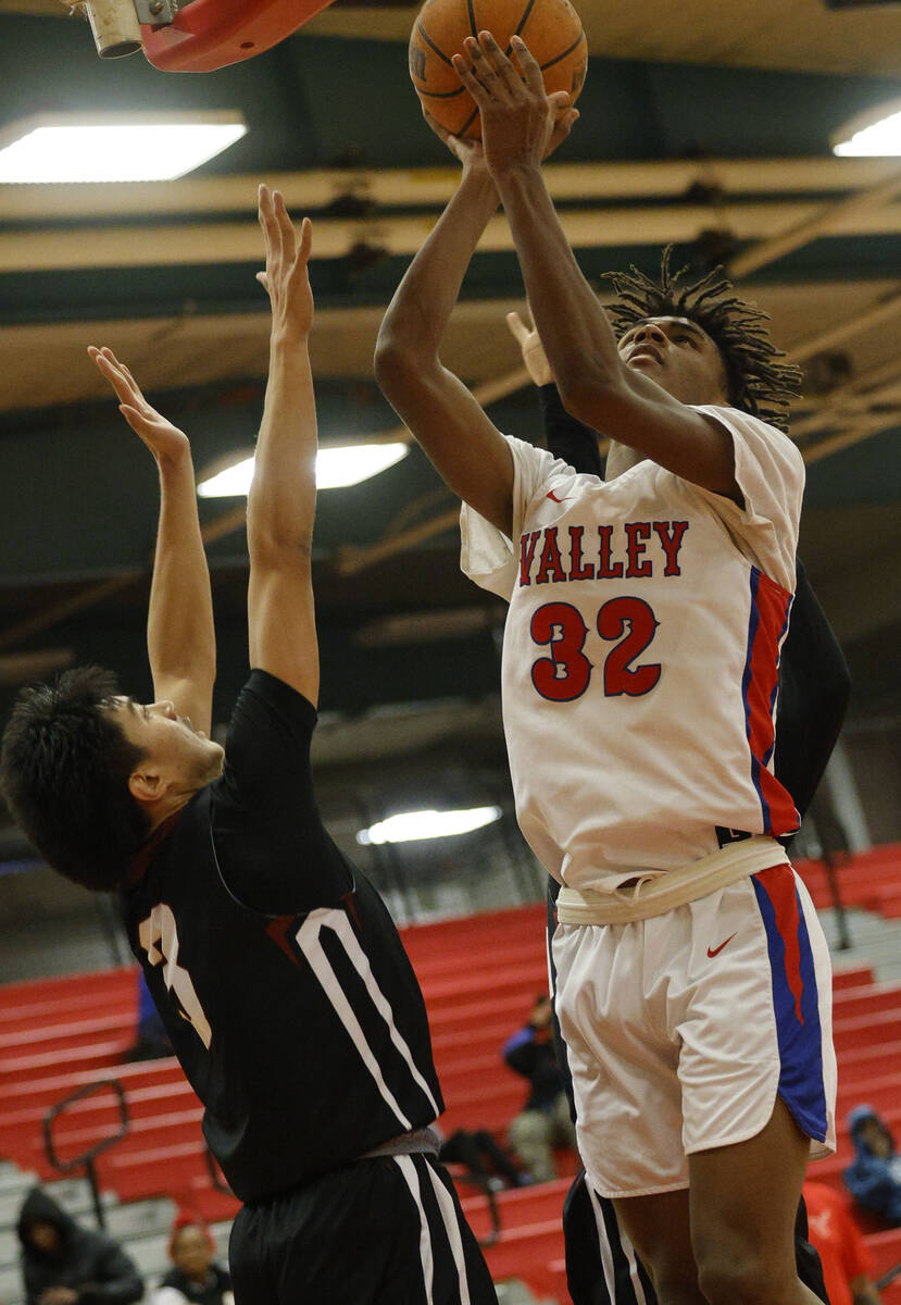 Valley's Xavier Shufford (32) shoots over Desert Oasis' Jayden Jones (3) during the second half ...