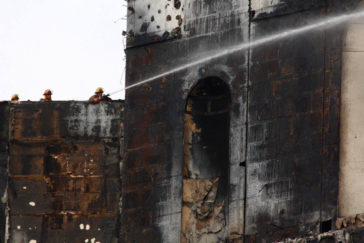 Firefighters douse hotspots on the upper level floors of the Monte Carlo hotel-casino on Friday ...