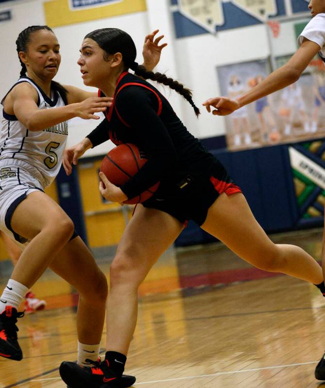 Coronado's Kaylee Walters (14), right, goes to the basket as Spring Valley's Gia McFadden (5) d ...