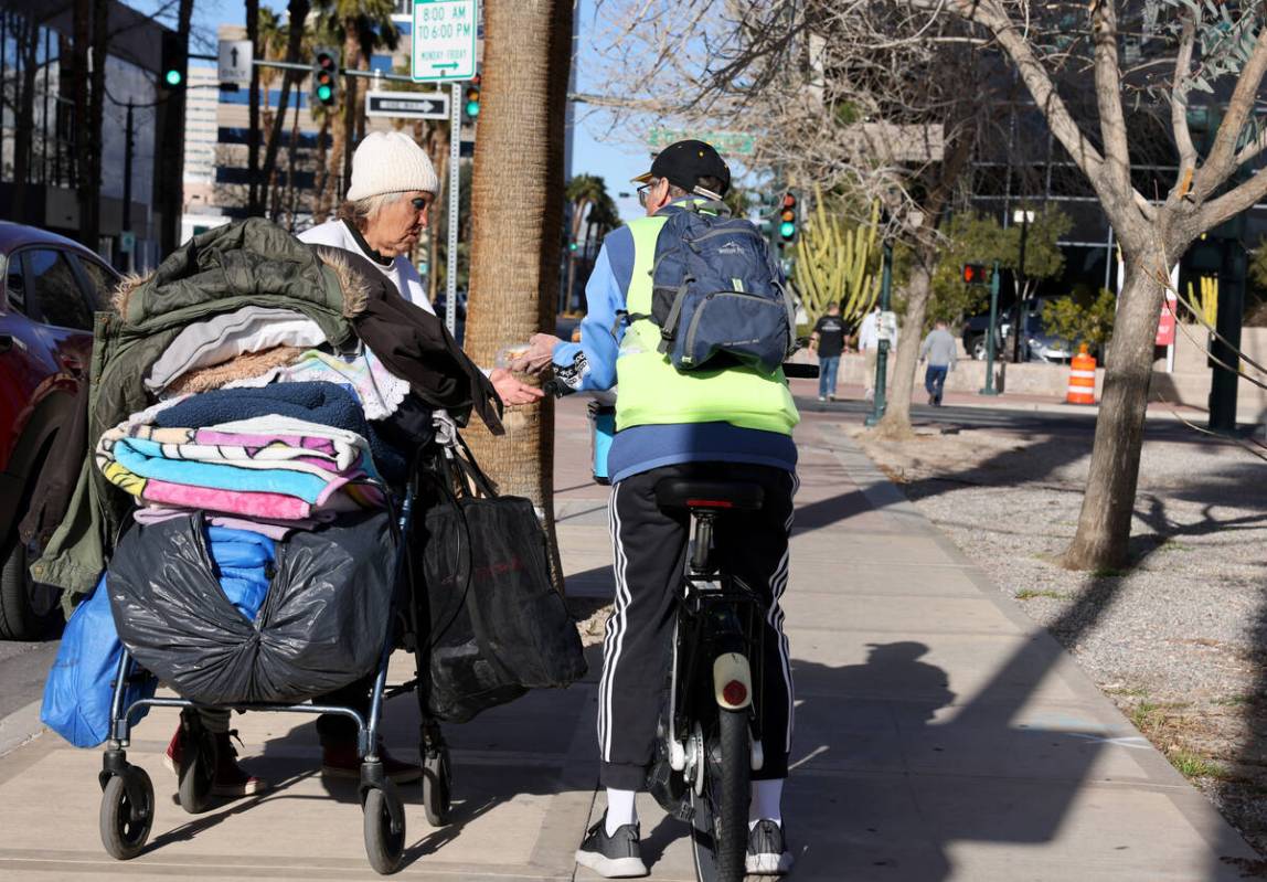 Richard Birmingham, right, offers food and resource information to Deidre Renderos, 50, during ...