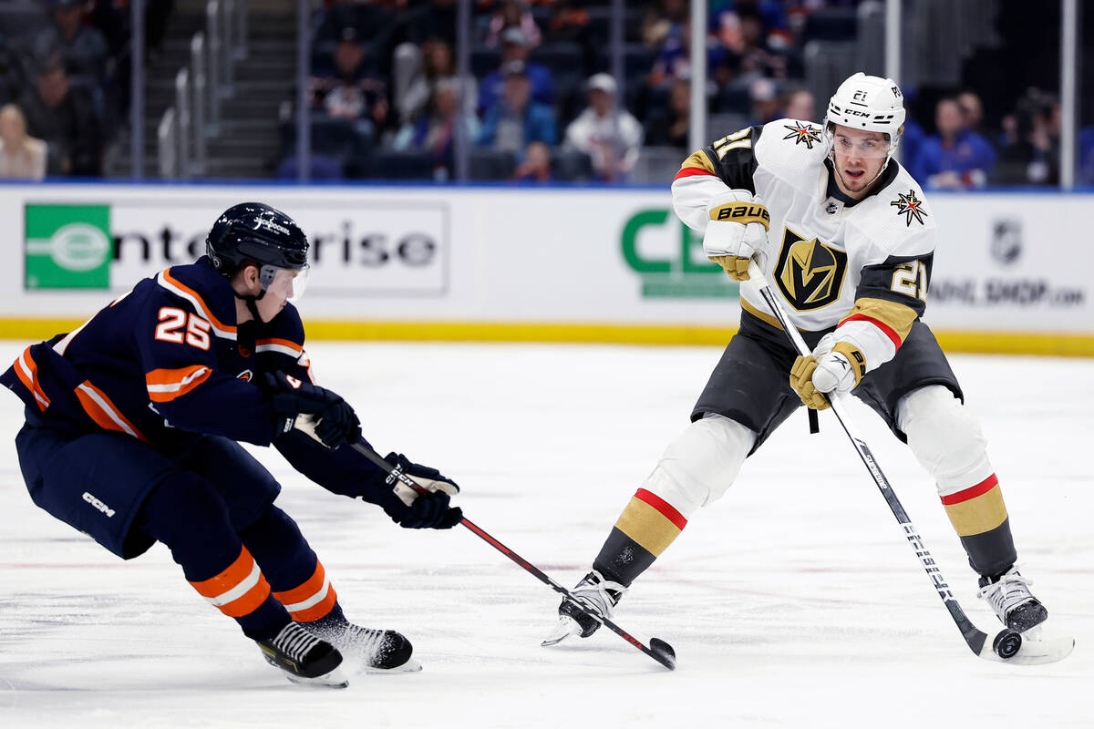 Vegas Golden Knights center Brett Howden (21) controls the puck next to New York Islanders defe ...