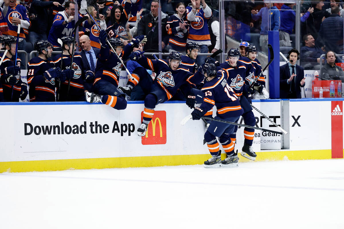 New York Islanders center Mathew Barzal (13) is congratulated by teammates after scoring the ga ...