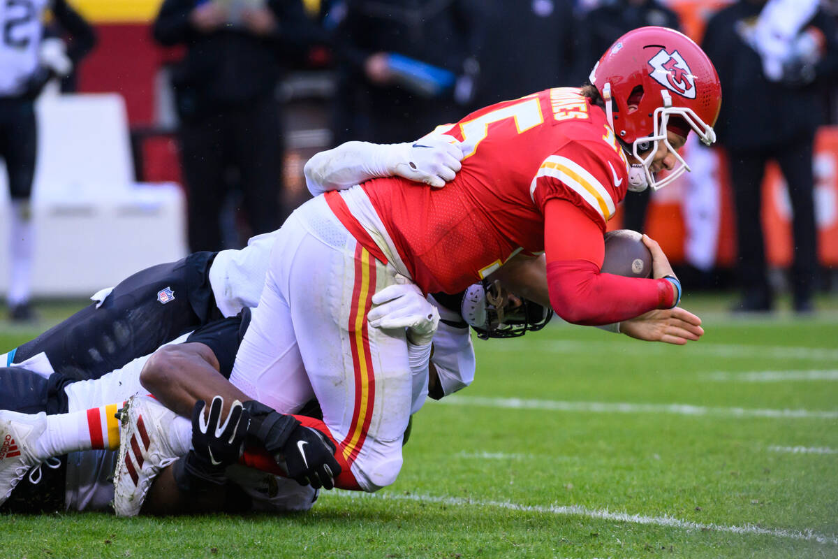 Kansas City Chiefs quarterback Patrick Mahomes (15) is tackled by Jacksonville Jaguars lineback ...