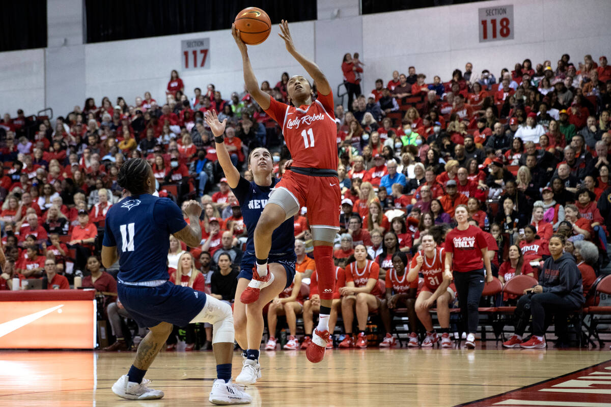 UNLV Lady Rebels guard Justice Ethridge (11) shoots against Nevada Wolf Pack guard Kaylee Borde ...