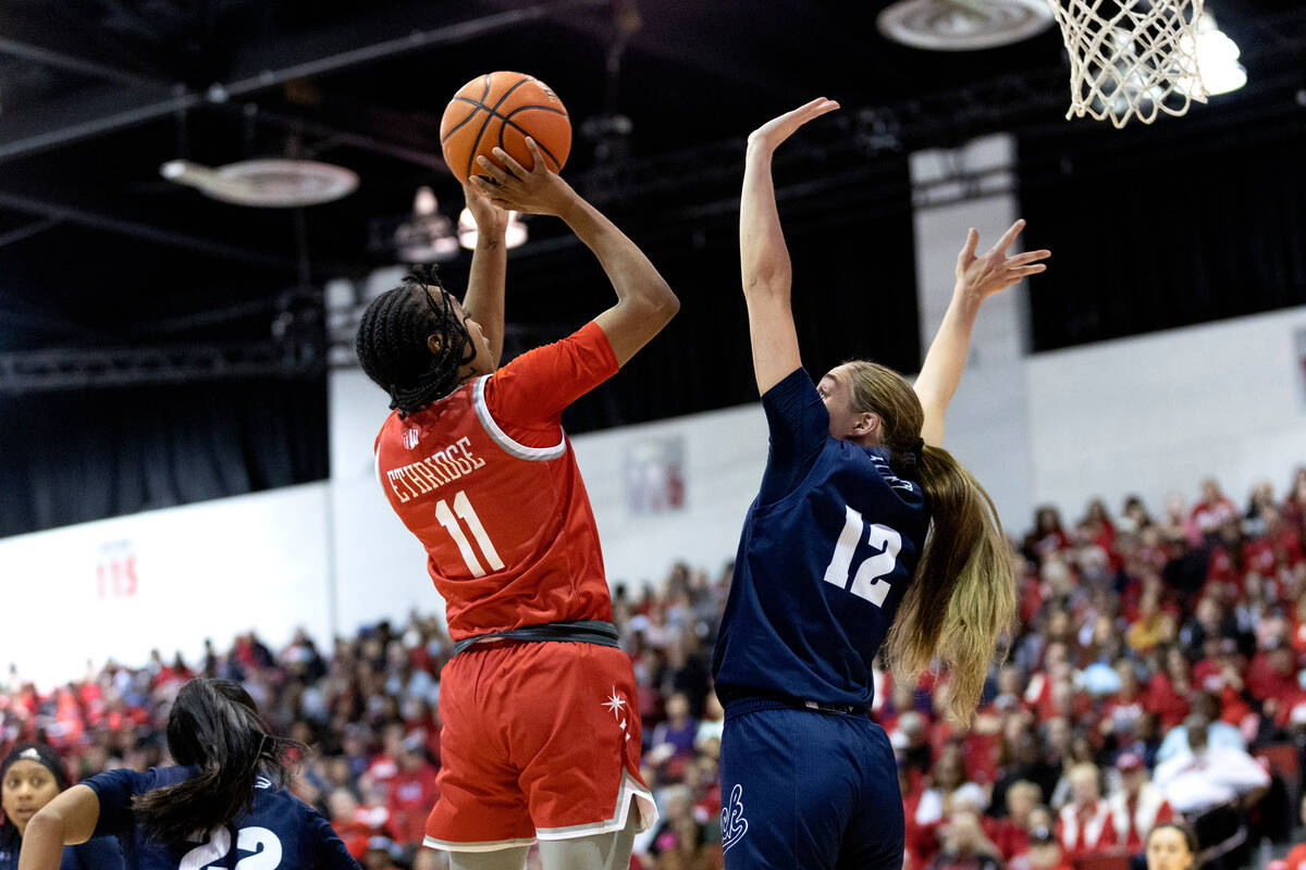 UNLV Lady Rebels guard Justice Ethridge (11) shoots against Nevada Wolf Pack guard Alyssa Jimen ...