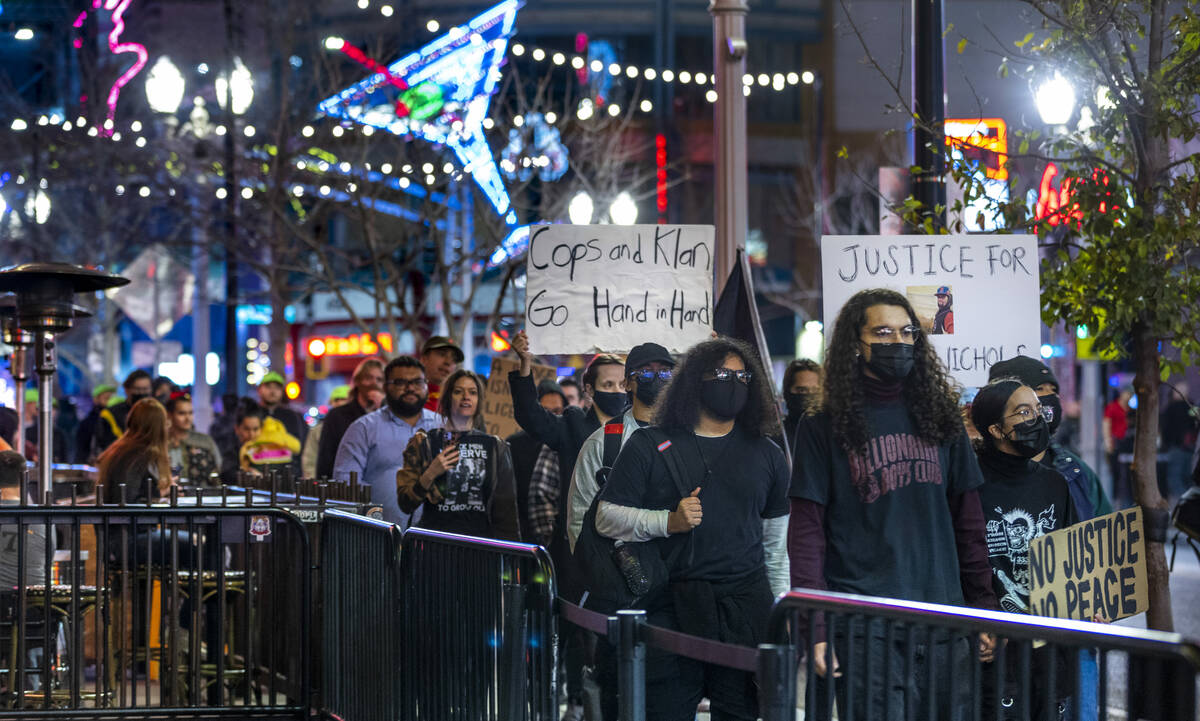 Participants march and chant along Fremont Street during a rally for Tyre Nichols organized by ...