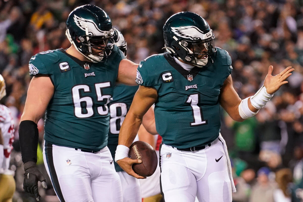 Philadelphia Eagles quarterback Jalen Hurts (1) celebrates his touchdown with offensive tackle ...