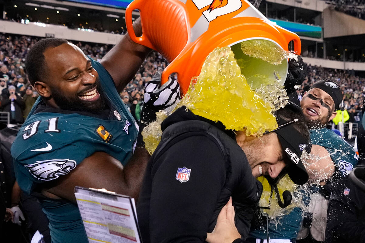 Philadelphia Eagles head coach Nick Sirianni, center, is doused by defensive tackle Fletcher Co ...