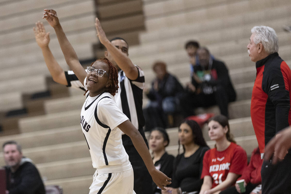 Cimarron-Memorial’s Dazani Graham celebrates after shooting a three-pointer during a gir ...