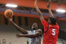 Desert Pines' Greg Burrell (5) shoots around Coronado's Lantz Stephenson (5) during the first h ...