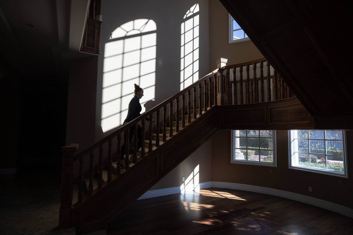 Ann Mabeus, who recently became a real estate agent, walks through a house in the Anthem Countr ...