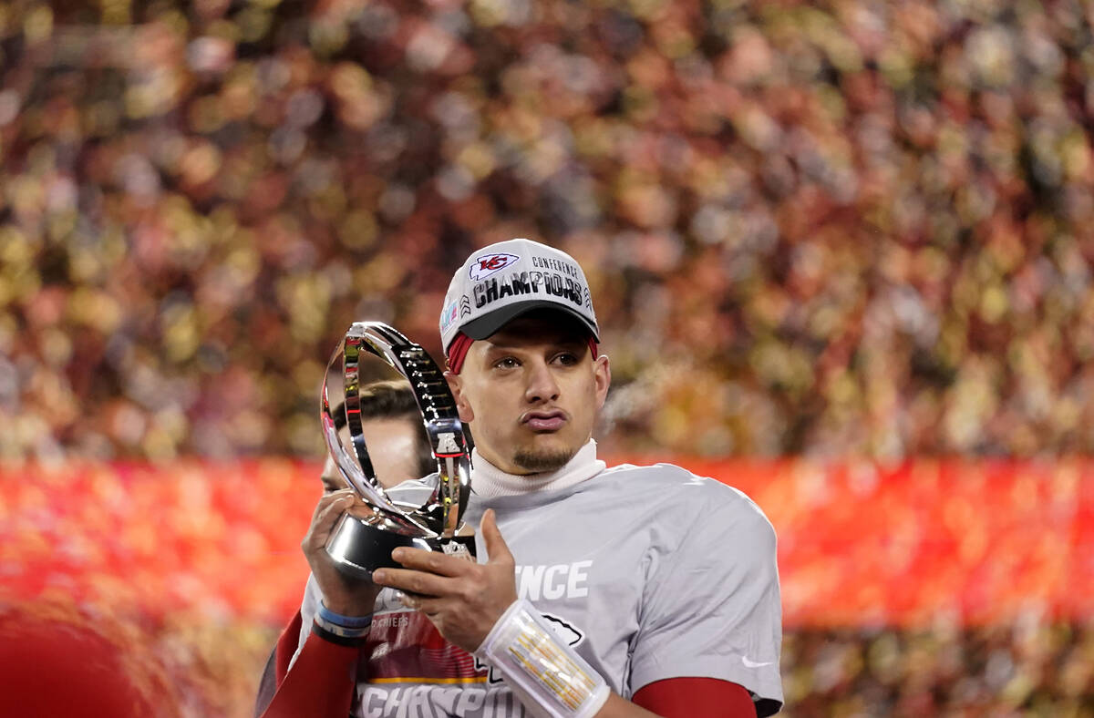 Kansas City Chiefs quarterback Patrick Mahomes holds the Lamar Hunt Trophy after the NFL AFC Ch ...