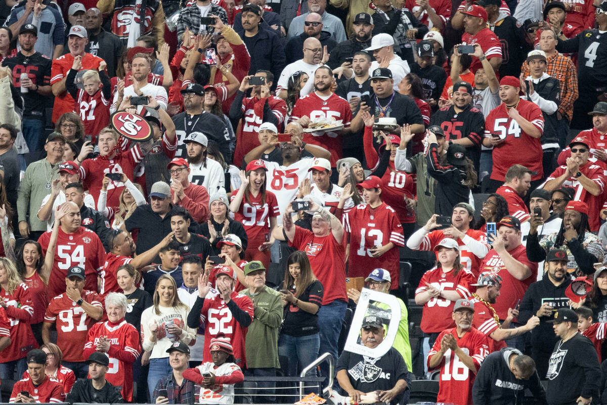 A sea of San Francisco 49ers fans take over a section in Allegiant Stadium for an NFL game agai ...