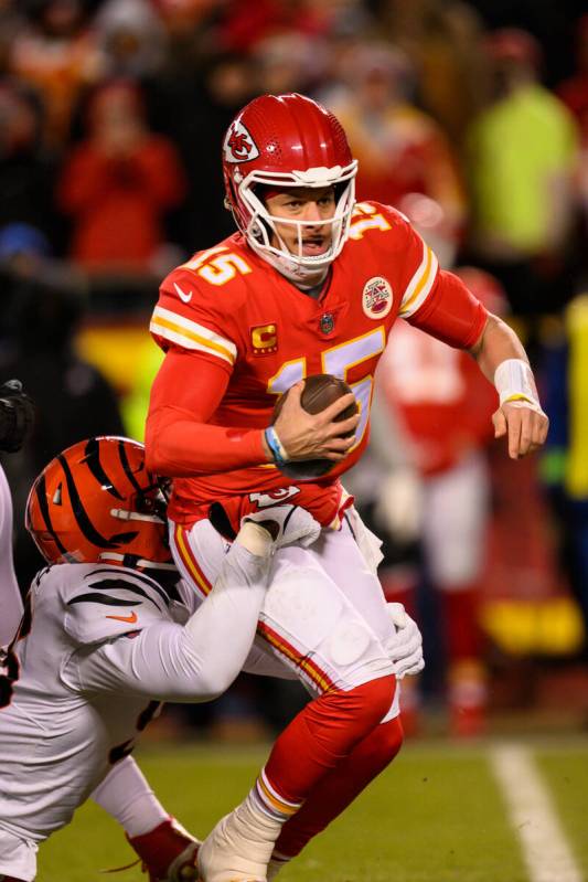 Kansas City Chiefs quarterback Patrick Mahomes (15) is tackled by Cincinnati Bengals defensive ...