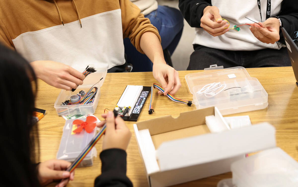 Senior James Phan, left, and sophomore Keoni Johnson work with circuits in a project during the ...