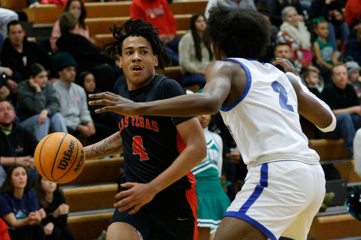 Las Vegas' Marcus Gomez (4) tries to drive past Green Valley's Scott Hammond (2) during the fir ...