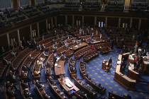 FILE - In this image from video, members of the House practice social distancing as they sit on ...