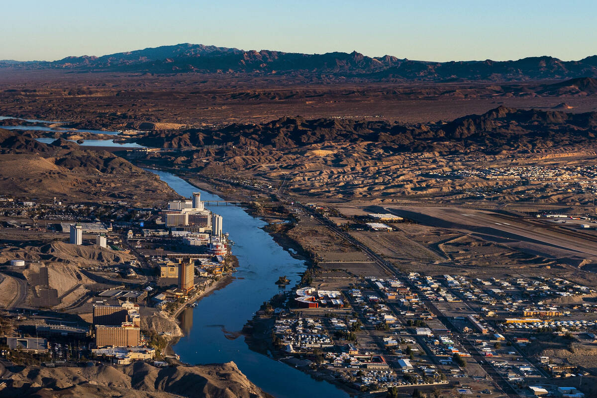 Morning lights the downtown Laughlin, Nev., waterfront, left, and Bullhead City, Ariz., along t ...