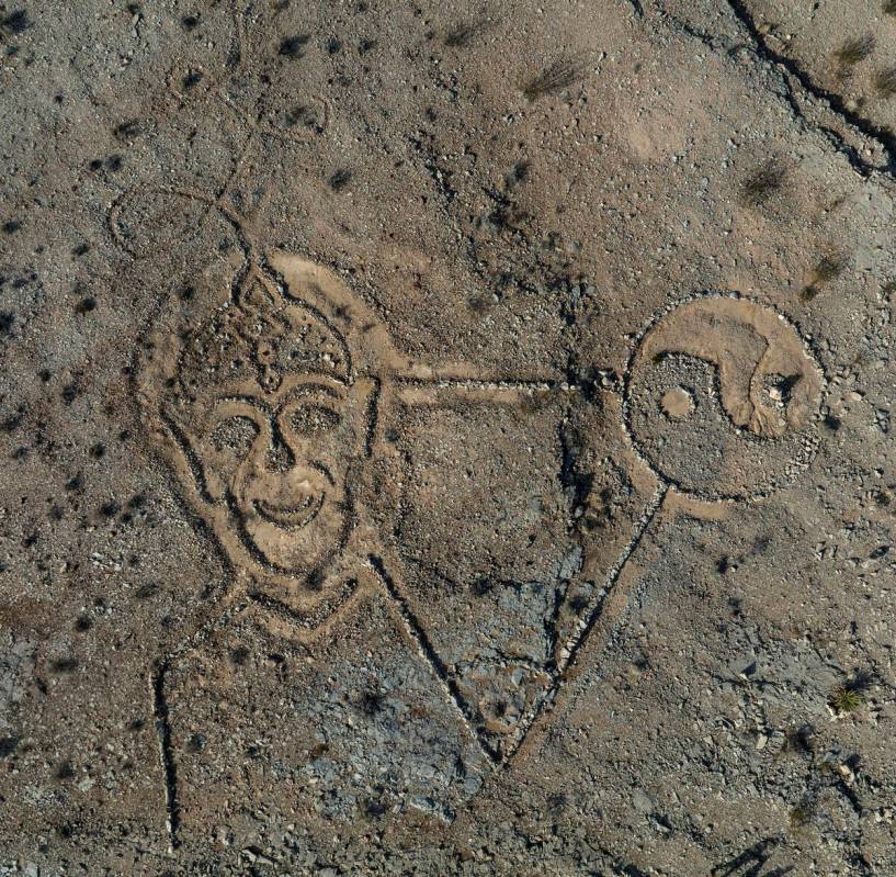 Rocks arranged by an unknown person in the shape of a large triangle with a yin yang at one poi ...