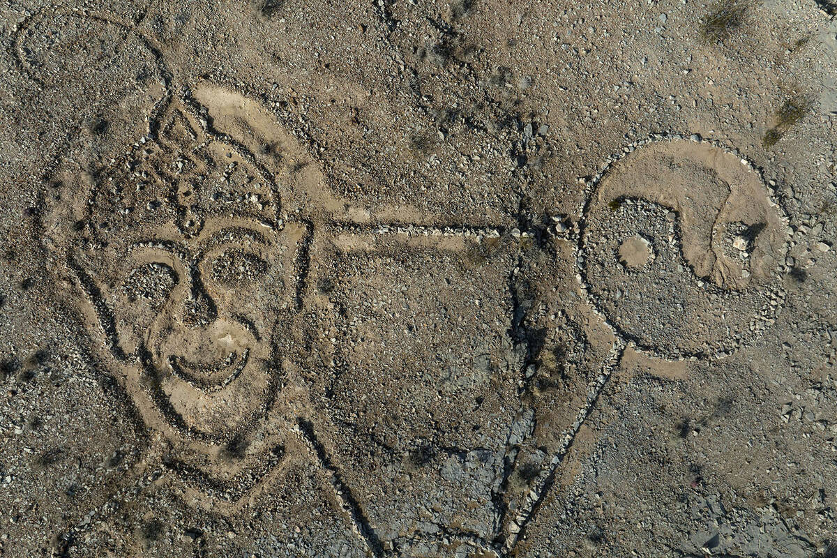 Rocks arranged by an unknown person in the shape of a large triangle with a yin yang at one poi ...