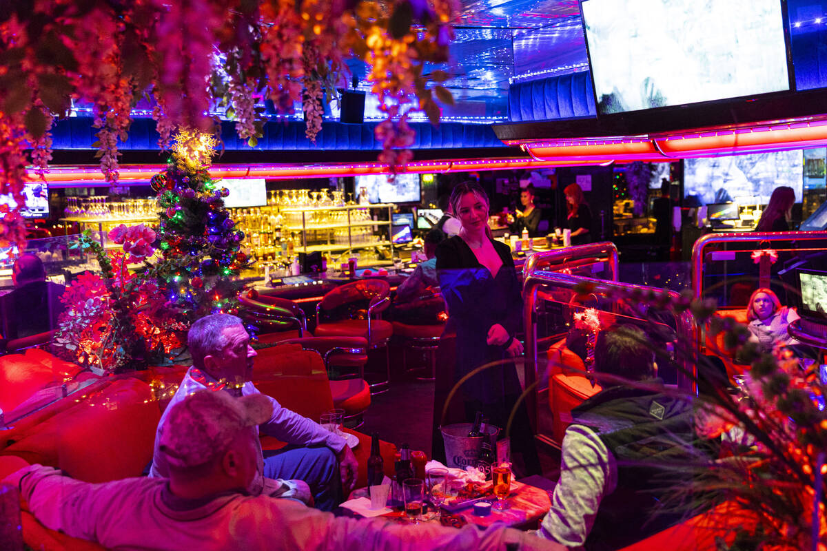 Cocktail waitress Behati Perry checks in with patrons in the Fireside Lounge at Peppermill on T ...