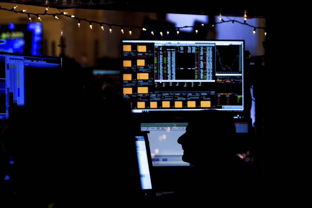 A trader works on the floor at the New York Stock Exchange on Wednesday, Dec. 14, 2022, in New ...