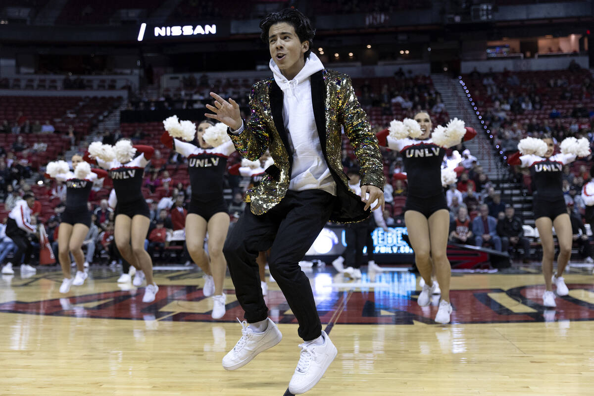 Freshman Jonathan Jaramillo performs with the Rebel Girls & Company during a timeout of a UNLV ...