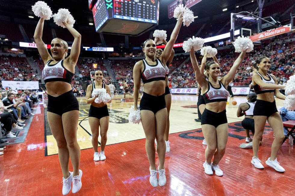 The Rebel Girls & Company cheer for their team from the sidelines during a UNLV basketball game ...